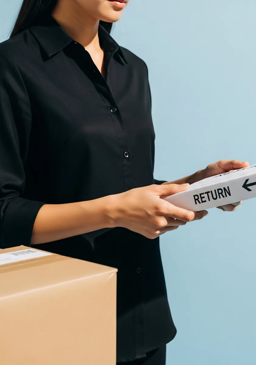 A customer holding a parcel labelled for return